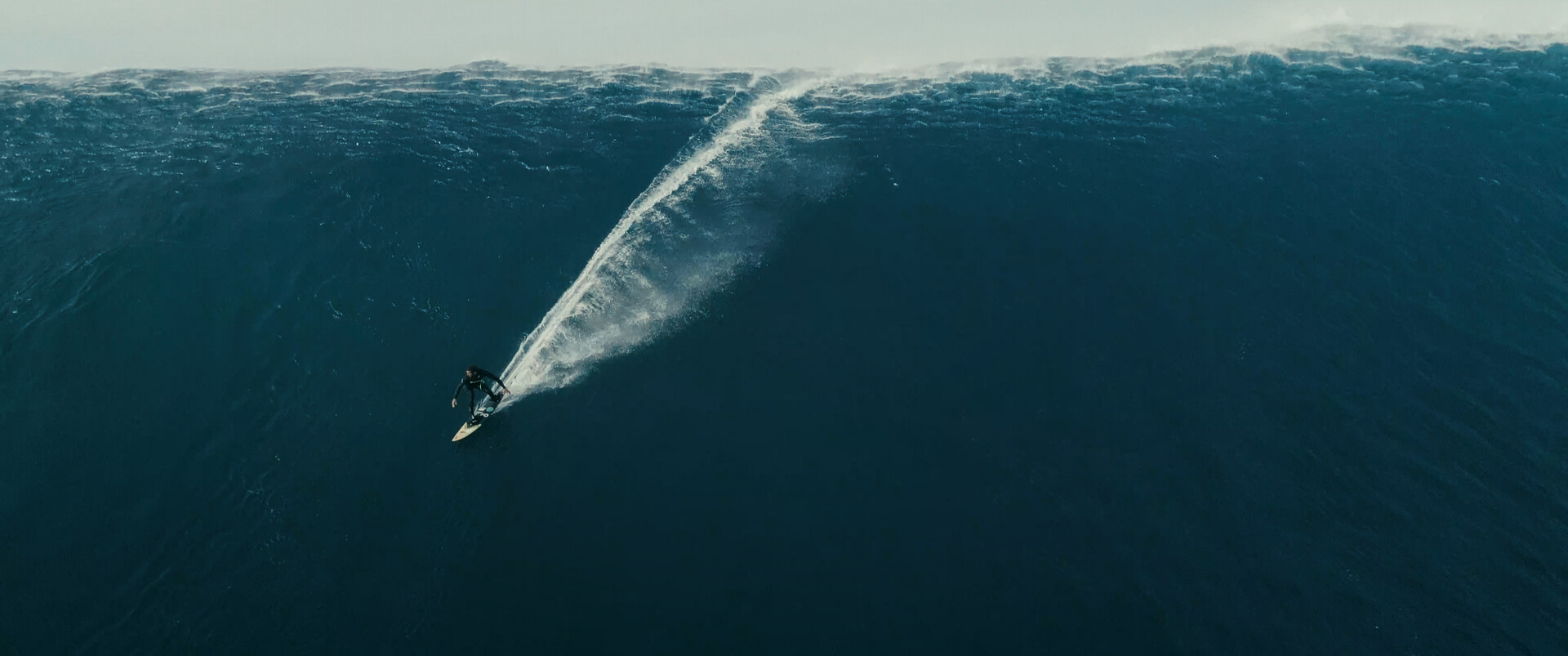 a surfer on the face of a huge wave