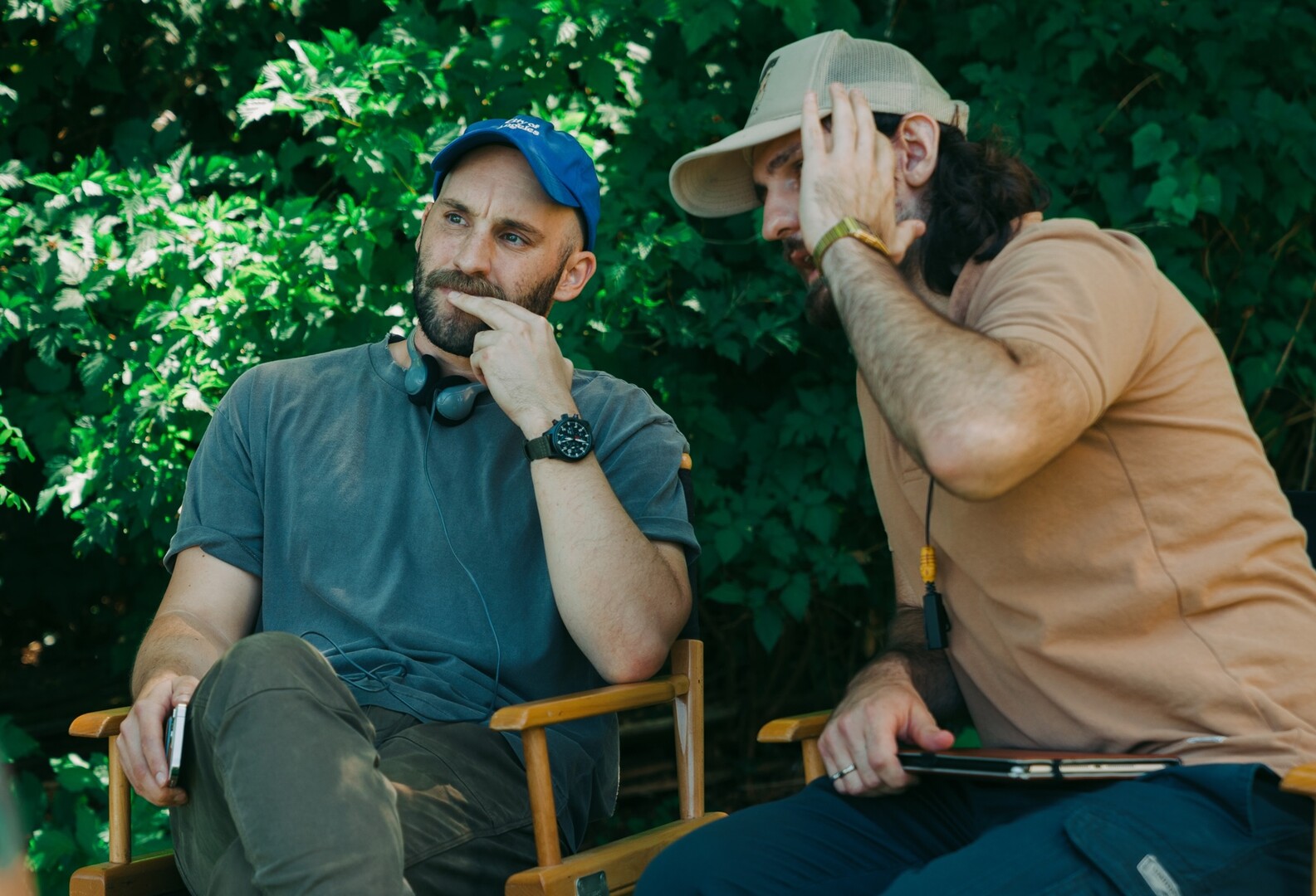 Two men sitting in chairs outside